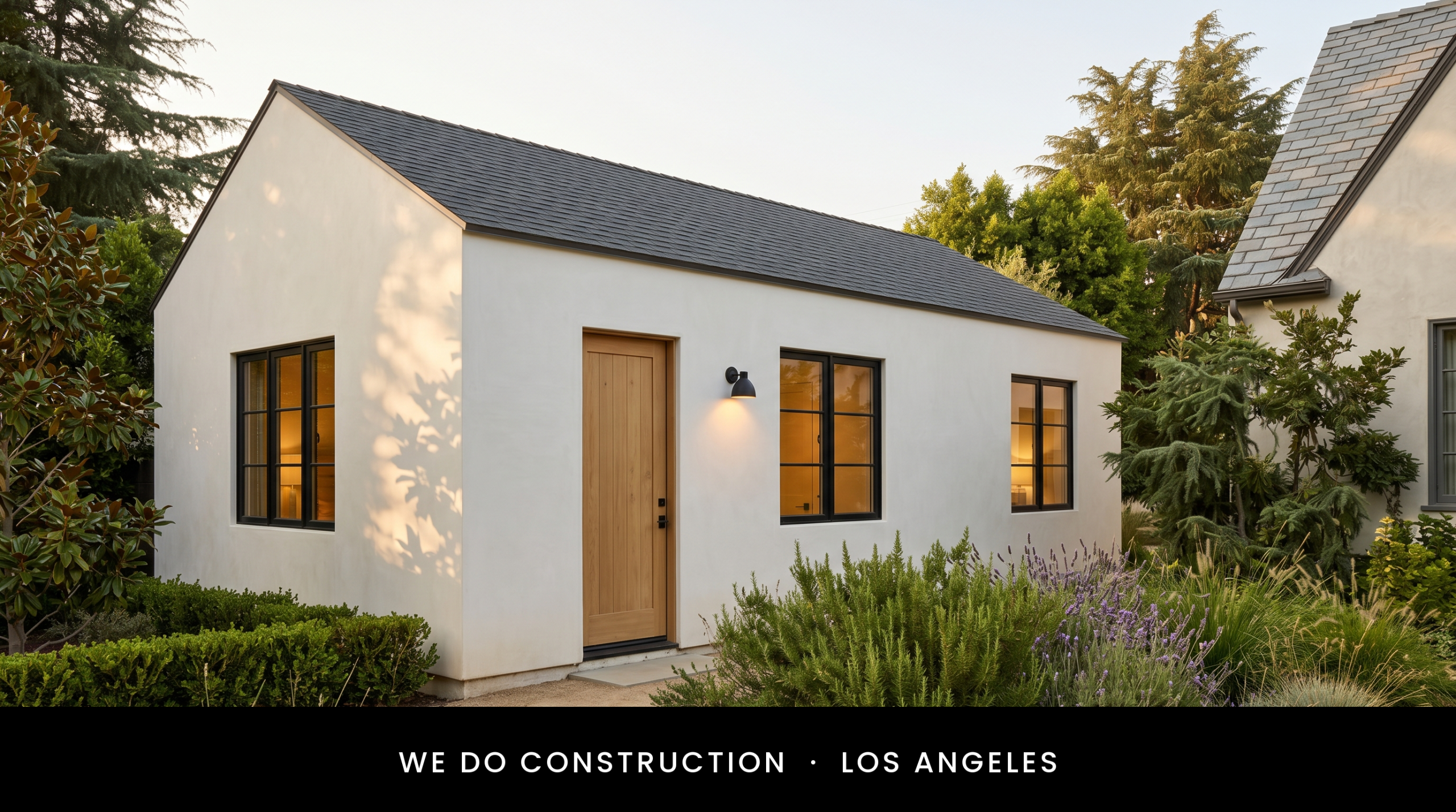 White stucco gable + deodar cedar setback — Hancock Park new addition.